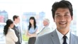 Happy businessman standing upright in front of his team
