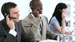 Happy call centre agents working together with headsets