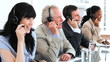 Happy brunette call centre agent working with her colleagues