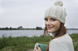 Young woman holding mug, close-up, portrait