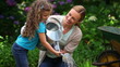 Mother and daughter watering flowers together