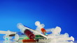 Many multicolor syringes rotating on blue, 2 views, loop ready