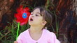 Video: Happy little girl blowing on a pinwheel Happy little girl blowing on a pinwheel