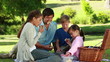 Family eating sandwiches during a picnic