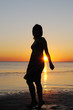 Portrait of young woman as silhouette by the sea