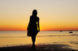 Portrait of young woman as silhouette by the sea