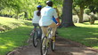 Boy riding a bike with his parents