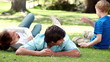 Family lying together on the lawn