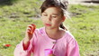 Happy little girl using a bubble wand