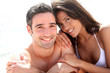 Portrait of romantic couple laying on the beach
