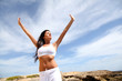 Woman stretching arms towards the sky