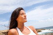 Woman sitting on rocks in fitness outfit