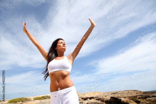 Photo: Woman stretching arms towards the sky Woman stretching arms towards the sky