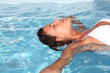 Photo: Woman relaxing in swimming-pool Woman relaxing in swimming-pool