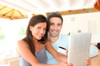 Couple at home doing online shopping with tablet