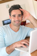 Man at home connected on internet with laptop Man at home connected on internet with laptop