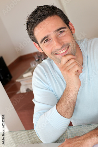 Photo: Portrait of smiling man working from home Portrait of smiling man working from home