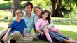 Happy children coming then sitting with their parents