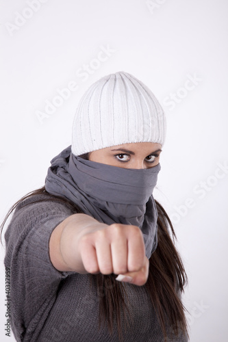 Photo: Young masked woman with closed fist Young masked woman with closed fist