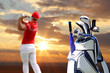 Man playing golf with golf bag