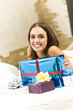 Happy smiling woman with gifts at home