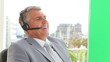 Businessman gesturing while talking on a headset