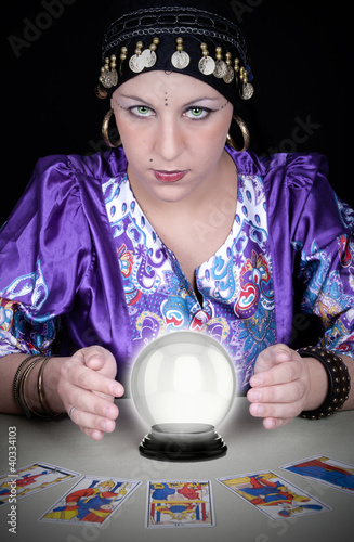 Photo: Gypsy fortuneteller uses a crystal ball Gypsy fortuneteller uses a crystal ball