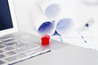 Red model house and laptop