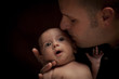 Young Father Holding His Mixed Race Newborn Baby