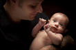 Young Father Holding His Mixed Race Newborn Baby