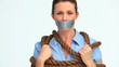 Businesswoman attached with a rope and having tape on her mouth