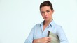 Serious business woman with a newspaper crossing her arms