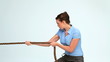 Video: Young businesswoman pulling a rope Young businesswoman pulling a rope