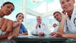 Video: Medical team looking at camera as computer screen Medical team looking at camera as computer screen