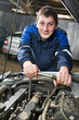 happy automotive mechanic at work with wrench happy automotive mechanic at work with wrench