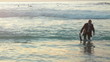Business man walks out of the ocean
