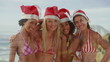 Four girls posing together in bikinis