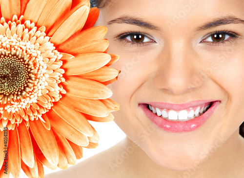 Photo: Beautiful woman smile with flower. Beautiful woman smile with flower.