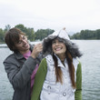 Young couple enjoying in front of river