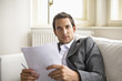 Businessman holding pen and document, portrait