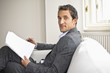 Businessman holding pen and document, portrait