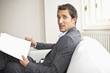 Businessman holding pen and document, portrait