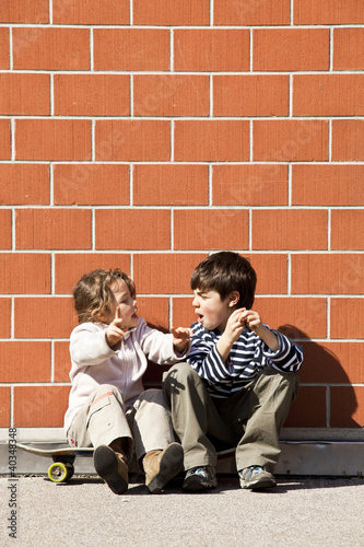 Photo: two children squabbling two children squabbling