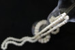 Pearl necklace of glass cups on a black background