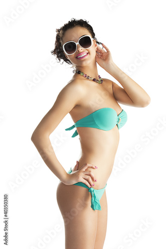 Photo: girl in beach wear with sunglasses with body turned in profile girl in beach wear with sunglasses with body turned in profile