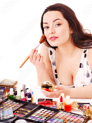 Photo: Girl applying makeup. Girl applying makeup.