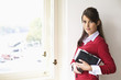 Young woman holding diary, portrait