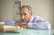 Photo: Businessman leaning on table, close-up Businessman leaning on table, close-up