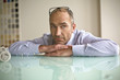 Photo: Businessman leaning on table, close-up Businessman leaning on table, close-up
