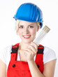 Young woman with building-site helmet and yardstick